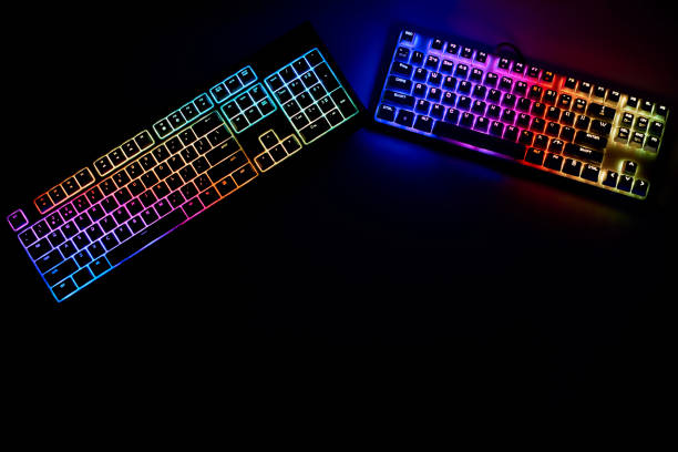 istock Gaming equipment. Two gaming keyboards, on a black background. Multi-colored keyboard, top view 1336345664