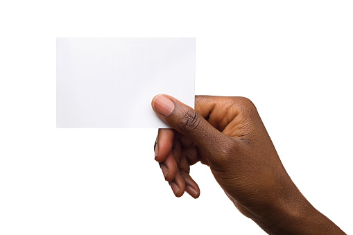 Close up of black woman's hand holding blank white card.