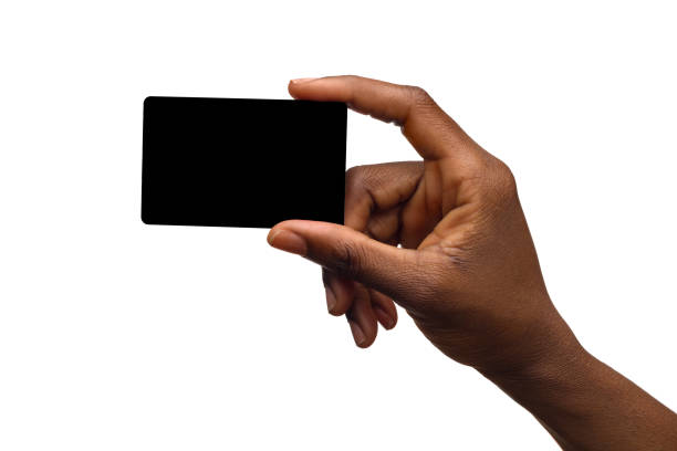 Black Female Hand Holding Empty Black Card Close up of black woman's hand holding empty black card. Studio shot isolated on white. human hand stock pictures, royalty-free photos & images