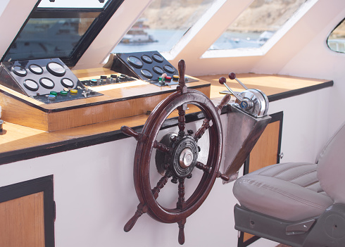 the captain's cabin. steering wheel, instruments, chair, navigation equipment