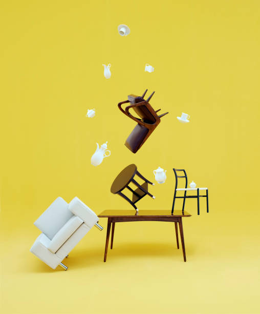 zero gravity flying furniture on a yellow background - cair no sofá imagens e fotografias de stock