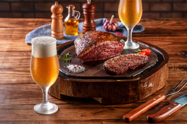 bistecca di groppa alla griglia e birra (picanha brasiliana) - strip steak immagine foto e immagini stock