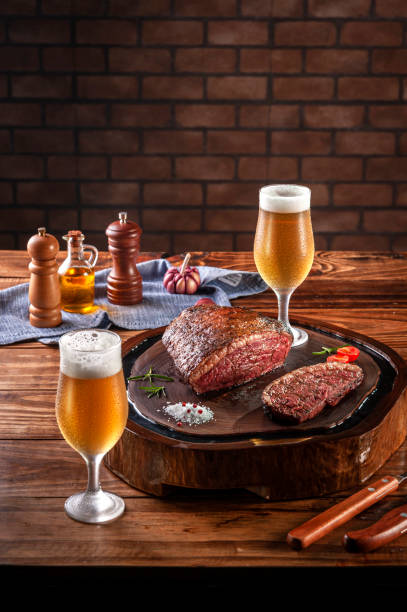 grilled cap rump steak and beer (brazilian picanha) - picanha beef meat rare imagens e fotografias de stock