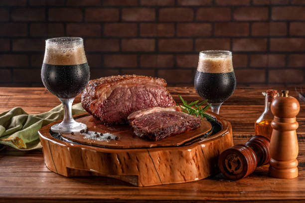 istock Dark draft beer with grilled strip loin. 1336348581