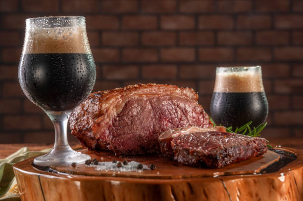 dark draft beer with grilled strip loin. - picanha beef meat rare imagens e fotografias de stock