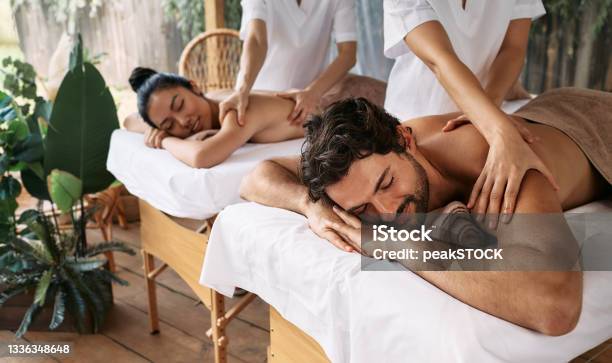 Couple Massage At Spa Resort Beautiful Couple Getting A Back Massage Outdoor Romantic Weekend And Relax Stock Photo - Download Image Now