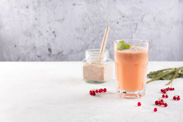 a glass of smoothies made of red currant berries and coconut milk with the husk of plantain seeds . the concept of healthy eating - healthy eating food and drink nutrition label food imagens e fotografias de stock