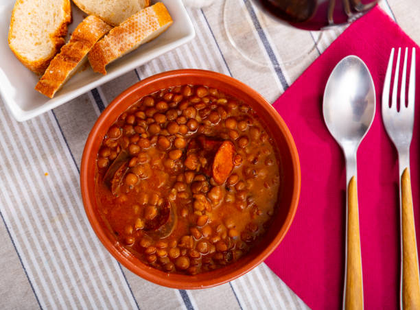istock Stewed lentils with chorizo and vegetables in earthenware bowl 1336355987