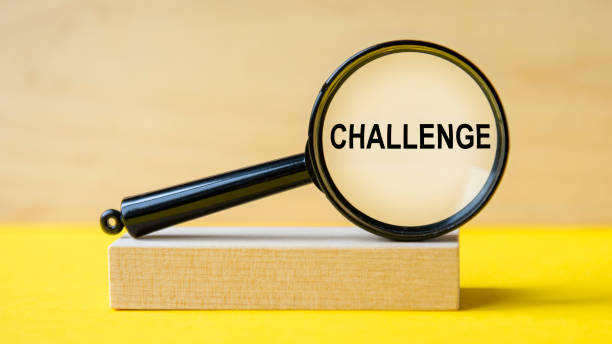 istock challenge word through magnifying glass on wooden background 1336356813