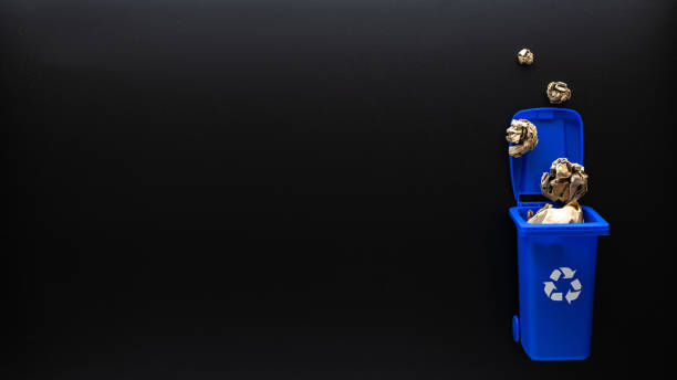 istock Recycle paper garbage. Blue dustbin for recycle paper trash on black background. Bin container for disposal garbage waste and save environment. Copy space. 1336358447