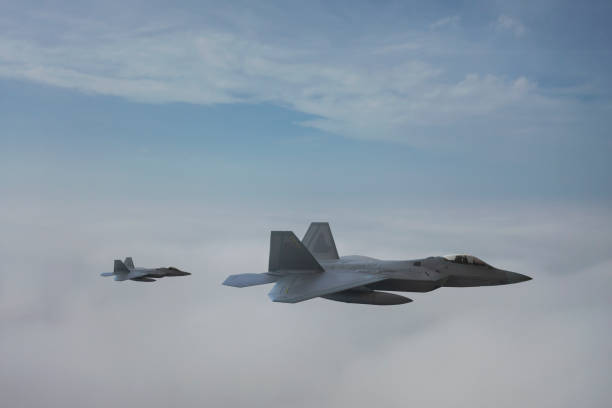 istock Jet fighters flying over the clouds. 1336358718