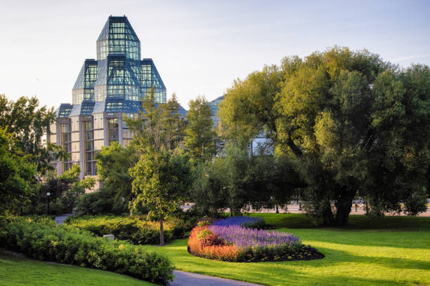 Ottawa, Canada - September, 24, 2024:  Tired travelers, homeless and inhabilitants rest in the beautiful public park in the shadow of the Fairmont hotel and the canadian parliament in Ottawa