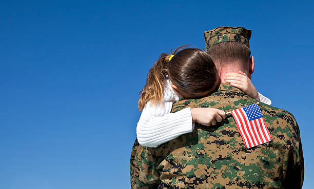 Military Father and Daughter Reunited Military man hugs his child national express stock pictures, royalty-free photos & images