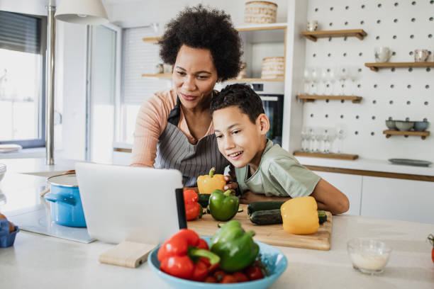istock Young boy cooking with his mother 1336363332