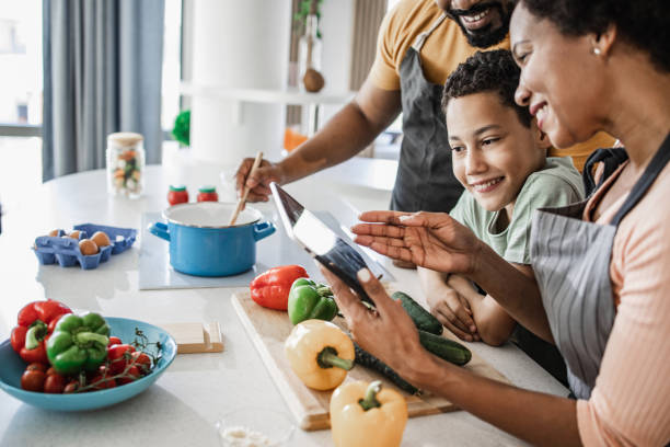 istock Family preparing dinner together 1336364135