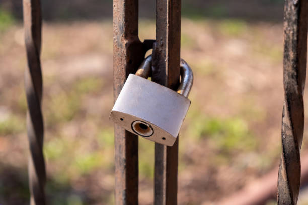 istock gray, old, rusty padlock weighs on an old fence 1336365766