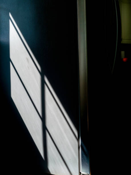 istock Shadows of the window with light falling on the wall 1336367362
