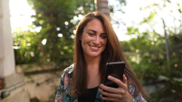 istock Woman using smartphone outdoors 1336369934