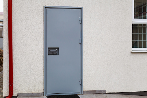The door of a prison or detention center. Background