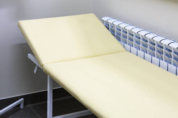 istock typical medical bed in doctors office. Background 1336371246