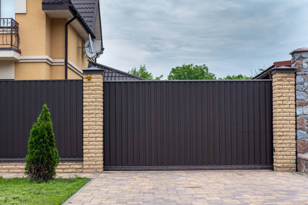 istock Modern brown corrugated iron fence with decorative brick columns. 1336371486