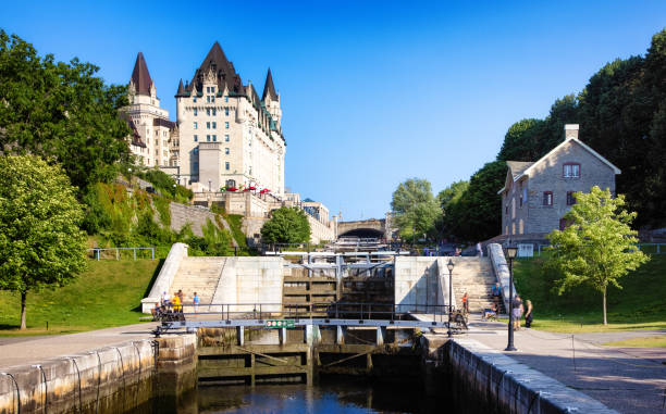 Ottawa Rideau canal locks looking towards the Chateau Laurier Ottawa Rideau canal locks looking towards the Chateau Laurier with several people enjoying this national park. chateau laurier stock pictures, royalty-free photos & images