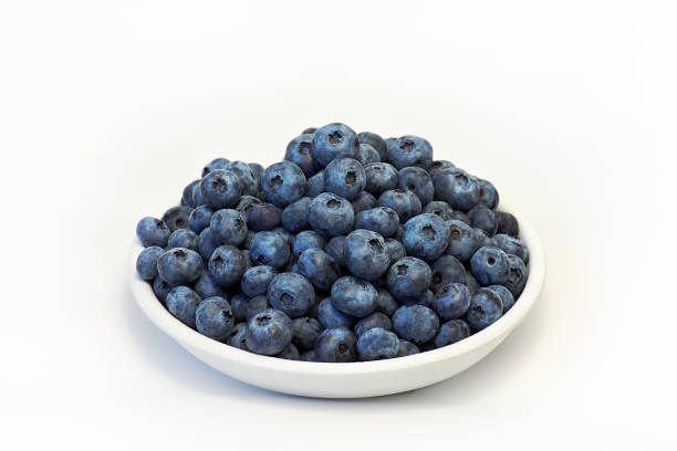 istock Fresh blueberries in white plate on white background 1336372854