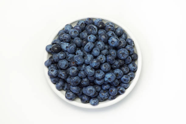 istock Fresh blueberries in white plate on white background, top view 1336372855