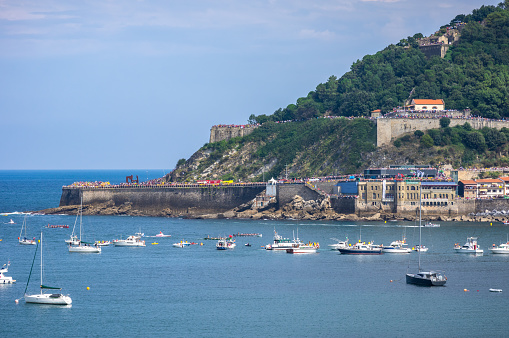 mount urgull, port,  boats and sea promenade in san sebastian