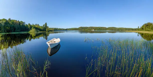 Small row-boat in a lake in Småland, Sweden.