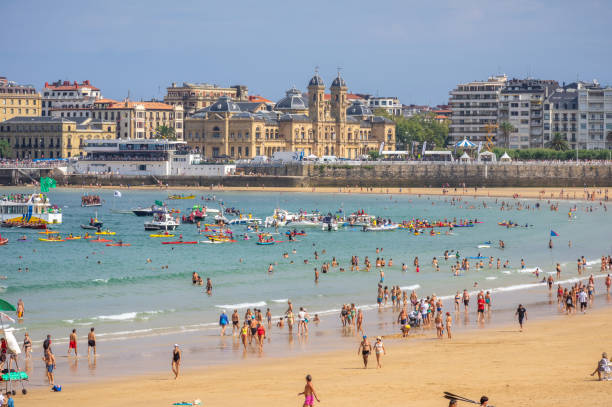 September 9, 2018 - Donostia San Sebastian, Spain: Tourists taking a bath in playa de la concha in Donostia San Sebastian, Spain