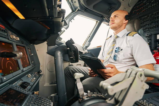 istock Serious male pilot staring at the aircraft control panel 1336374908
