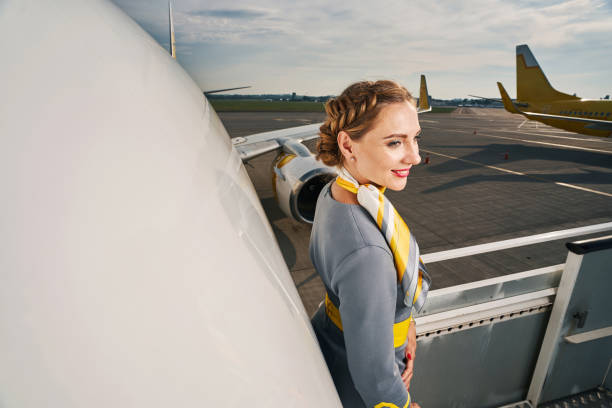istock Pleased elegant female flight attendant looking away 1336374915