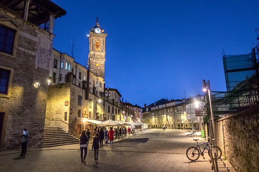 September 13, 2018 - Vitoria, Spain: people walking in front of St Vincent the Martyr Church, in matxete square,  Vitoria-Gasteiz at dusk