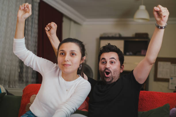 istock Young couple Watching TV at home 1336383295