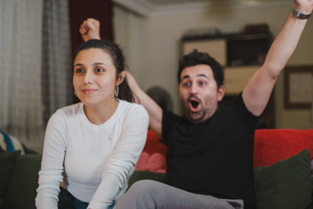 istock Young couple Watching TV at home 1336383297