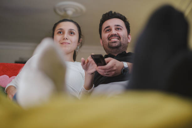 istock Young couple Watching TV at home 1336384540