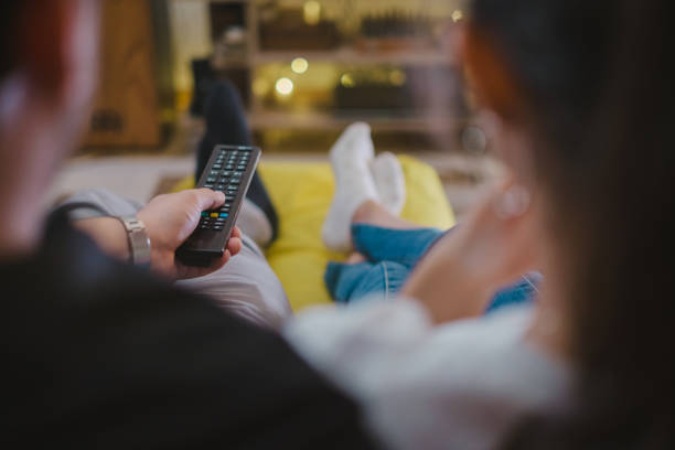 istock Young couple Watching TV at home 1336384544