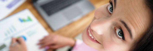 istock Woman is sitting office with reports and smiling 1336390750