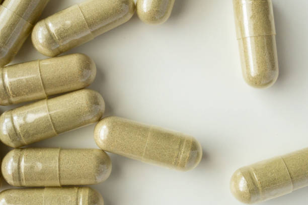 istock Herbal medicine capsules on white background 1336390872