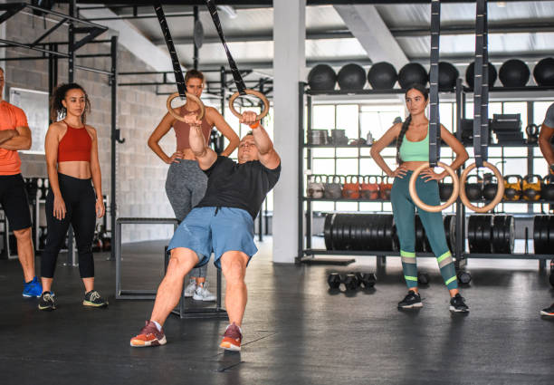 istock Fitness Instructor Demonstrating Gymnastic Ring Row Exercise 1336391369