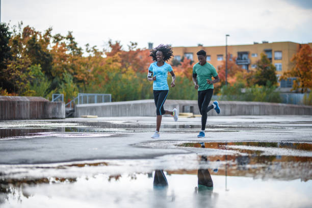 Active Black Friends Running Together After Rain Storm