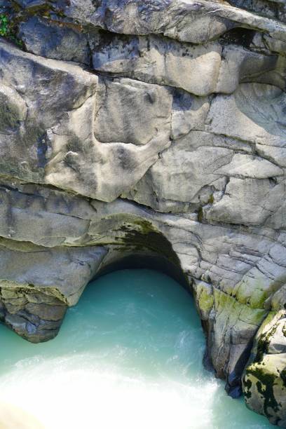 istock Glacial Water Carves out Rocky Face 1336393606
