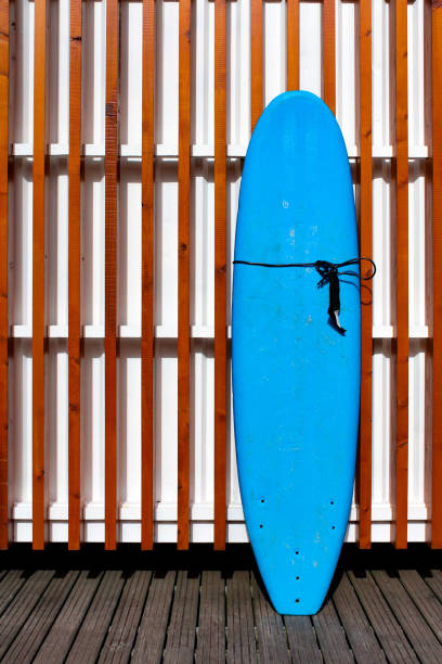 istock Blue surfboard and a wooden slat wall 1336396651