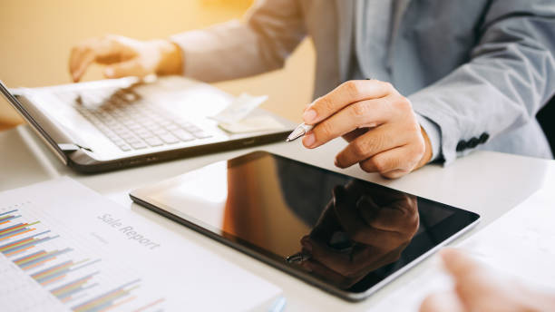 istock businessman working on project for analyzing company financial statistic result with smart device at modern office space. Concept for business, economy and tax. 1336399119