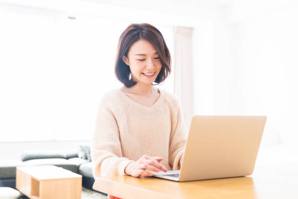 istock young asian woman using laptop 1336399197