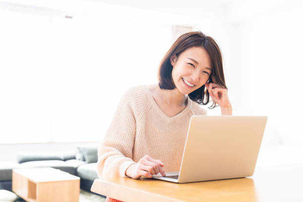 istock young asian woman using laptop 1336399200