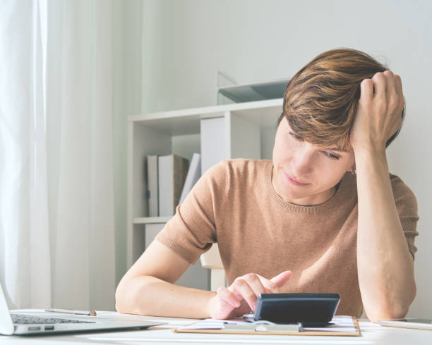 istock Focused middle aged female cutting back on spending. Money challenge during economic crisis 1336400961
