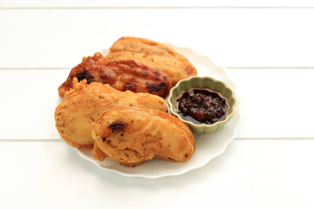Banana Fritter Pisang Goreng Sambal Roa or Fried Banana with Sambal Roa is One of the Typical Culinary Delights from Manado Indonesia, Top View on White Background gorengan stock pictures, royalty-free photos & images
