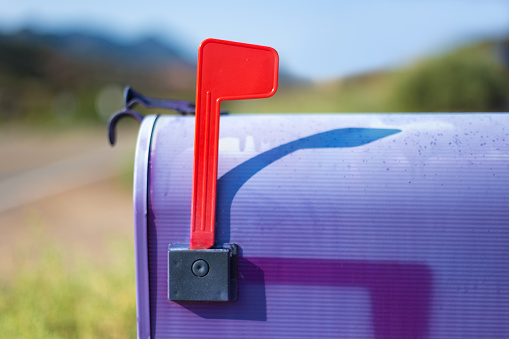 Rustic Classic Purple US Mailbox with Raised Red Flag. Shot in Santa Fe, NM.
